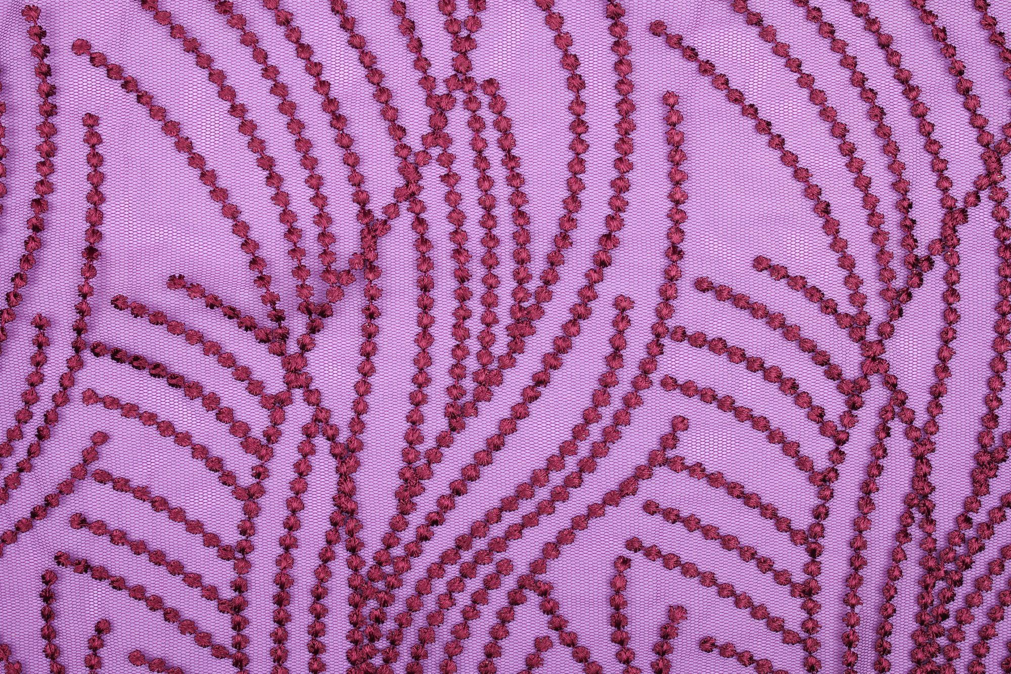 detailed macro of satin stitch forming geometric repeat