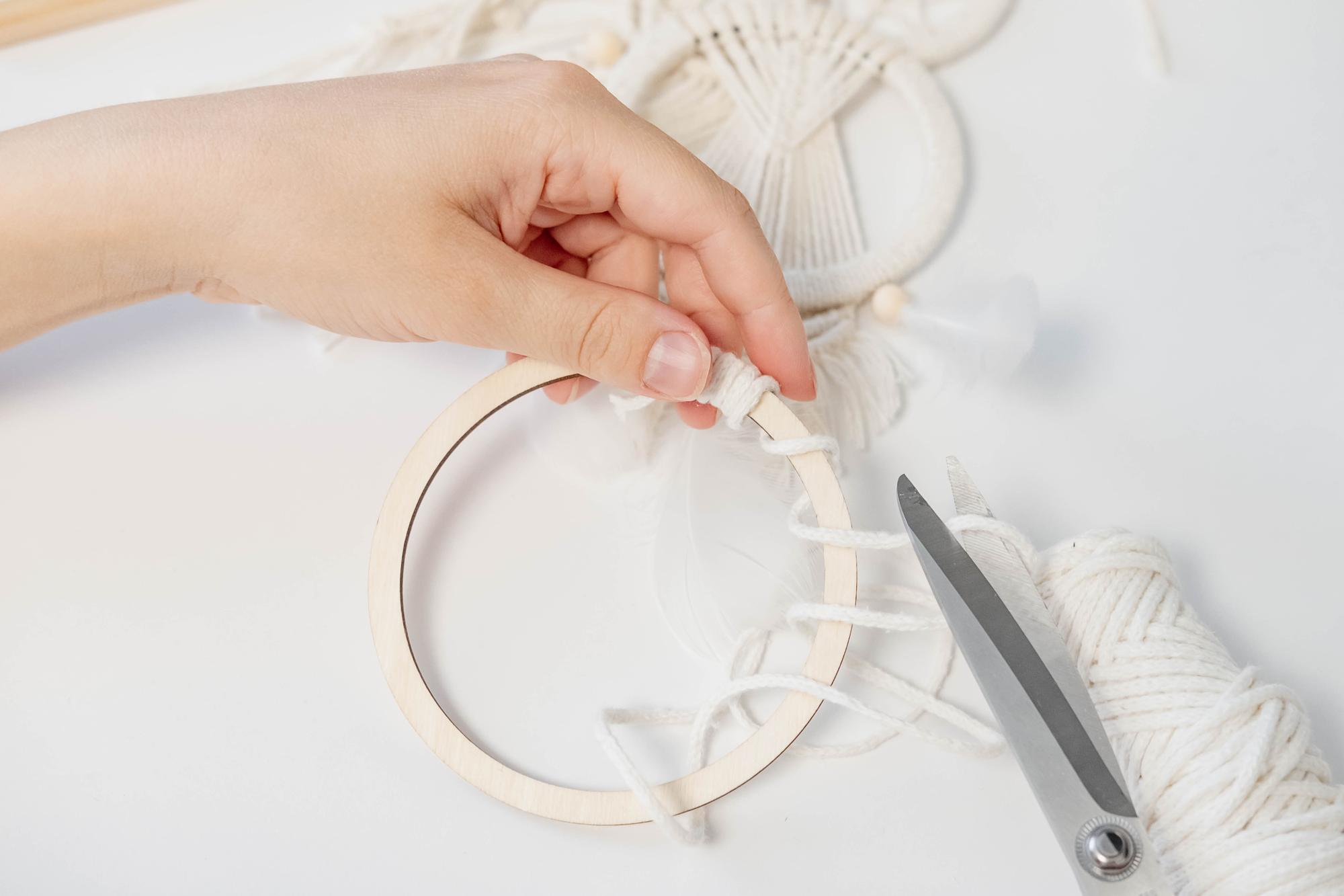 studio hands adjusting hoop under daylight