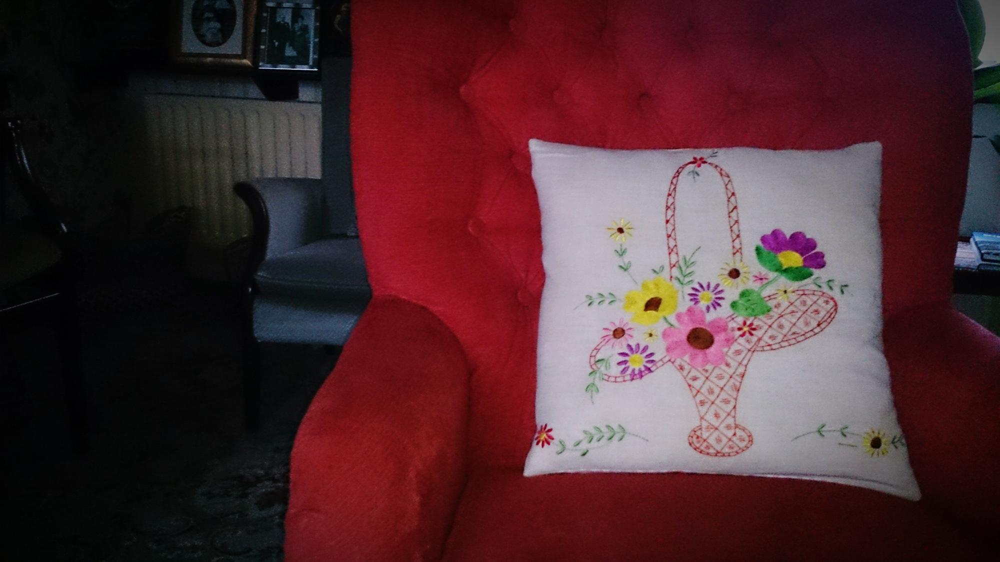 finished cushion with subtle embroidered motif in soft tones